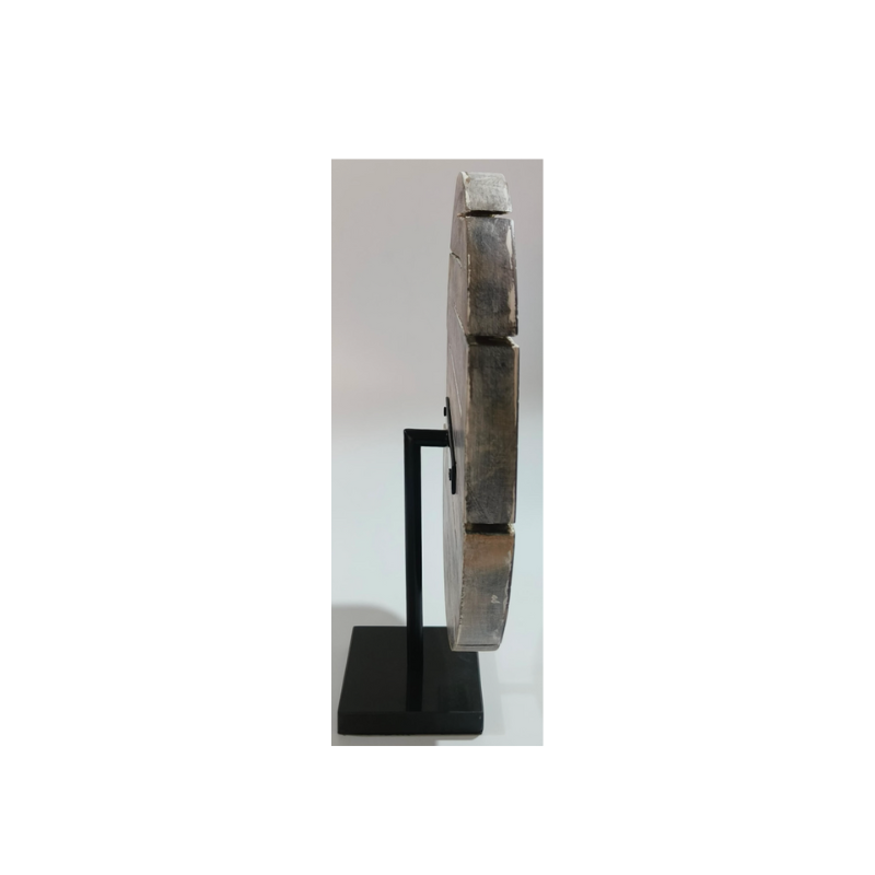 wooden carved object with black marble base